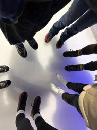 The group's skates in a circle on the ice, seen from above