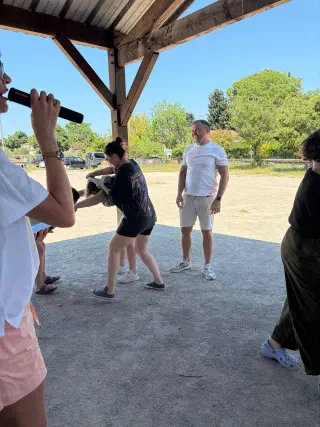 Games under the shelter: a host with a microphone and laughing participants
